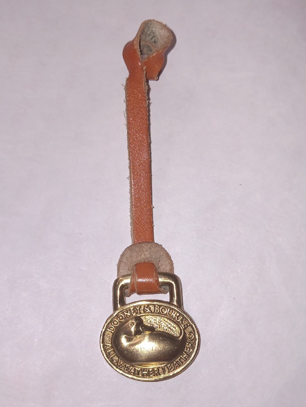 Dooney & Bourke Tan Leather Strap with Gold Medallion Charm